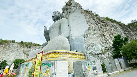Giant Buddha Carved in Stone Wat Khao ThamThiam at U Thong Province in Suphan Buri Thailand