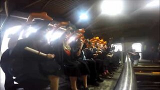 Students celebrate their graduation on a roller coaster