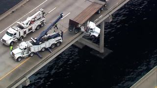 Aerial video: Truck hangs off I-75 bridge in Manatee County