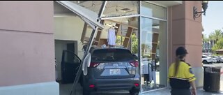 Woman drives into building