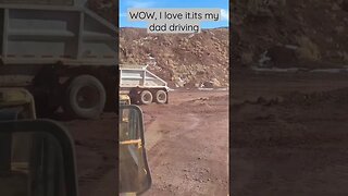 Dad driving a bulldozer.