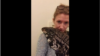 Huge pet lizard loves to cuddle with owner