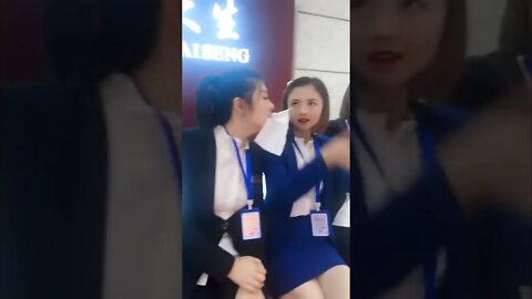 A Line Of Chinese Girls Pass Tissue From One Mouth To Another