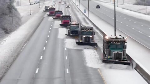 Snow fighters use synchronized snow plowing technique to clear highway