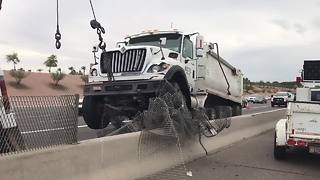 Crane lifts dump truck off median on US 60 near Val Vista