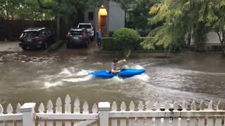 Canoeist paddles flooded street