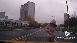 Crazy woman on motorway kicking cars