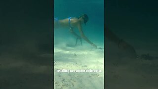 Girl replaces sailboat anchor underwater