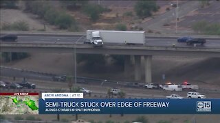 Semi-truck loses control, gets stuck on edge of freeway ramp