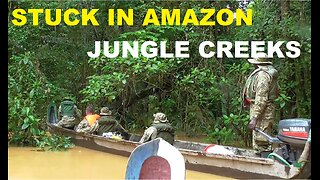 Canoe voyage through inaccessible creeks in the Amazon jungle