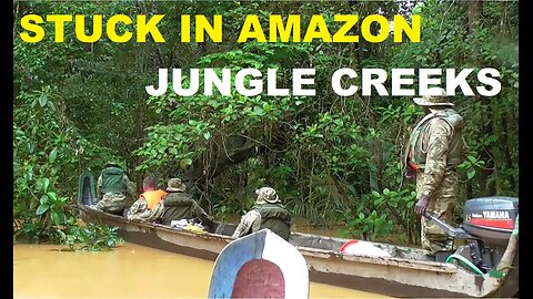 Canoe voyage through inaccessible creeks in the Amazon jungle