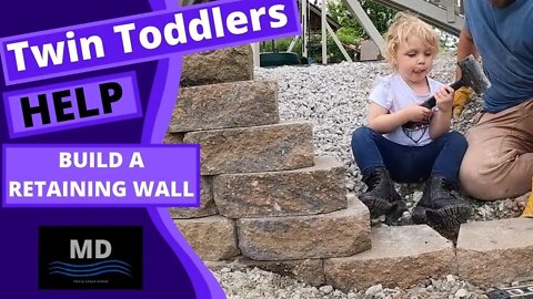 Twin Toddlers help Build a block retaining wall