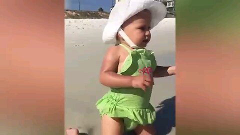 Funny babies playing on a beach