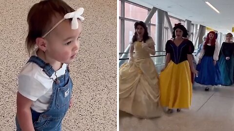 Toddler star-struck by fairytale encounter with Disney princesses
