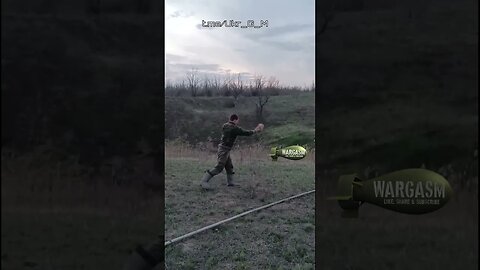Ukrainian soldier deactivates a mine using a rock