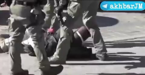 IDF soldiers beating on an unarmed Palestinian