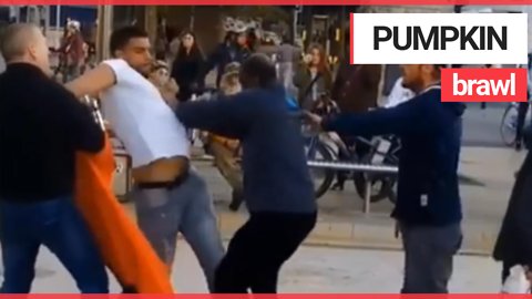 Shocking video shows 2 men fighting as woman carrying PUMPKIN tries to split them up