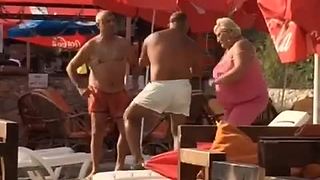Elderly people at the beach dance to rap music
