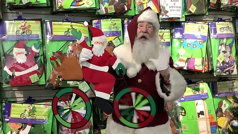Santa shows everyone a Santa garden spinner at Gift of Wings