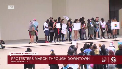 Protesters rally at Meyer Amphitheater in downtown West Palm Beach