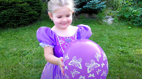 Diana plays with balloons in dresses of princesses