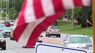 Lions Club honors service members with American flags on Metcalf Avenue