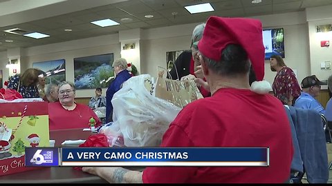 Men and Women in uniform give Veterans holiday cheer