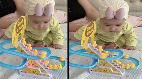 Infants Baby Girl is so confused with small duck Toy