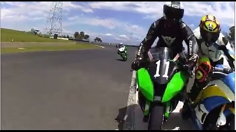 Moto GP racer gets a cheeky nudge off bike!