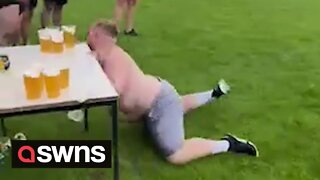 Rugby player taking part in beer slide challenge crashes into table and sends pints flying