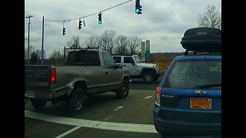 Jeep runs red stop light then truck narrowly misses hitting it