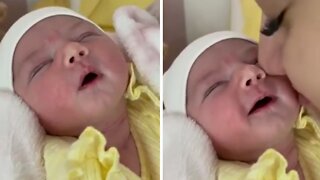 Newborn Baby Preciously Smiles When Kissed