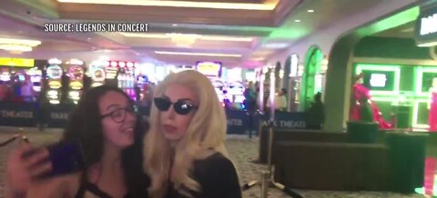 Fans pose with Lady Gaga impersonator