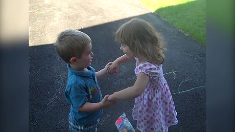 A Tot Girl And A Tot Boy Pretend To Marry Each Other