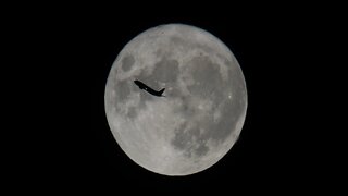 Plane passing by in front of the full Moon!