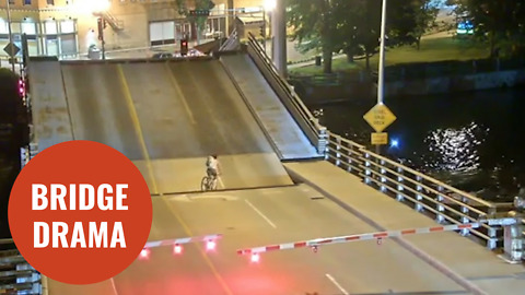 Cyclist ignores bridge warning barriers and falls into gap of drawbridge