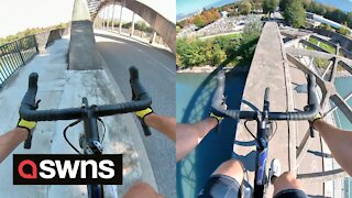 Watch as daredevil cycle across bridge arch in dangerous stunt