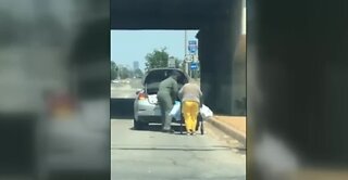 Airman helps woman with groceries