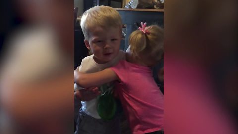 A Tot Boy Pushes A Tot Girl When She Gives Him A Hug