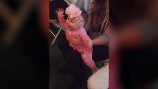 "A Baby Girl Dances to Music at A Wedding"
