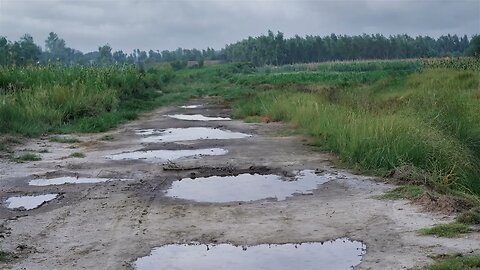 Rain in the puddles on a sandy farm road in Nowshera, Khyber Pakhtunkhwa, Pakistan