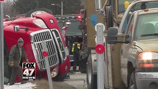 Semi-truck driver said she wasn't speeding after truck flips in Lansing
