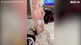 Mischievous toddler tries to remove diaper