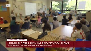 Surge in cases pushing back school plans