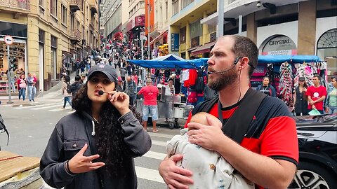 Preaching with the baby at Rua 25 de Março, São Paulo, Brazil