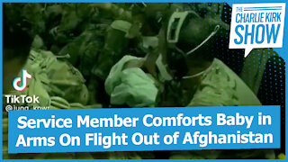 Service Member Comforts Baby in Arms On Flight Out of Afghanistan