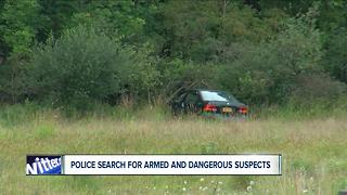 Police search for armed and dangerous suspects