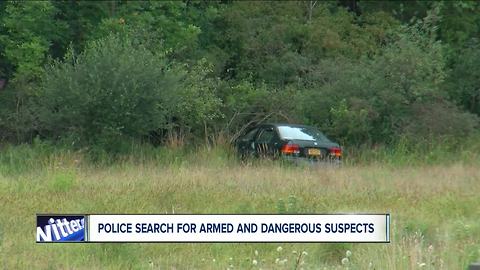 Police search for armed and dangerous suspects