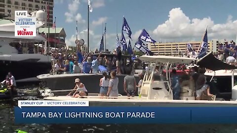 Coach Cooper hoists Stanley Cup during boat parade