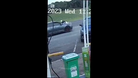 Thieves drive off from petrol station with owner clinging to bonnet.